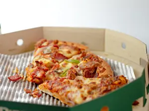 Pizza Prints: The remaining pizza is in the box.Empty pizza box with three slice remains. Top view