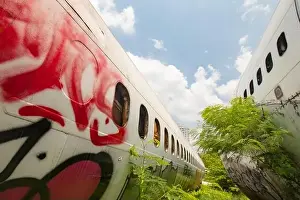 Air Traffic Prints: Remains of a wrecked and graffitied Boeing 747 and two McDonnell Douglas MD-80s in a field in Bangkok