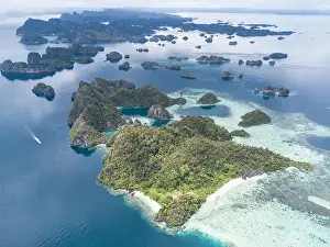 The remote limestone islands of Misool in Raja Ampat are surrounded by calm seas and healthy reefs. This tropical region has high marine biodiversity