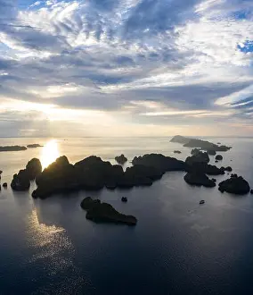 Remote limestone islands in Raja Ampat, Indonesia, are surrounded by healthy coral reefs. This biodiverse region is known for its marine biodiversity