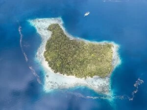 Aerial Landscape Collection: The remote limestone islands in Raja Ampat are surrounded by calm seas and healthy reefs