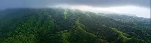 The remote, volcanic island of Sangeang rises from the seascape near Komodo National Park, Indonesia. This island is known for its black sand habitat