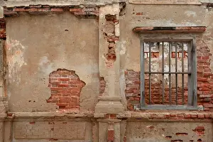 Distressed Prints: rendered concrete wall with exposed red brick and wooden jail cell like window