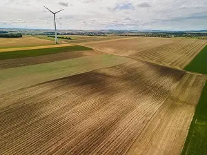Wind Farm Prints: Renewable Energy Wind Farm in Agriculture Fields in Countryside Drone Aerial View