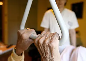 Social Issues Prints: A resident of a senior citizen centre holds on to a handle in Hamburg