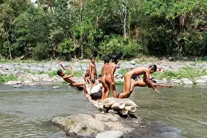 East Java Prints: Residents in Taman Krocok village, Bondowoso, use the river for bathing and for playing