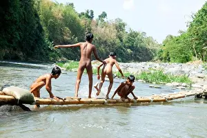 East Java Prints: Residents in Taman Krocok village, Bondowoso, use the river for bathing and for playing