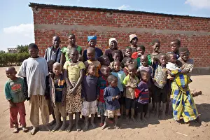 Residents Prints: Residents of a village gather to welcome Kubatsirana charity which helped many of these villagers build brick houses