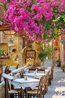 Images Dated 25th June 2017: Restaurant at Chania Old Town, blooming bougainvillea flowers, Crete Island, Greece