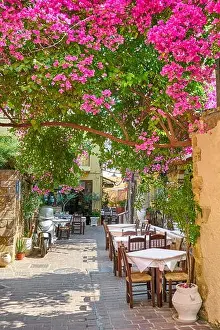 Restaurant at Chania Old Town, bougainvillea blooming flowers, Crete Island, Greece