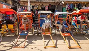 Madagascar Prints: Rickshaw pullers in Antsirabe with their brightly decorated pousse-pousse (meaning push-push in French)