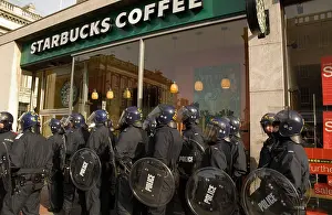 Trouble Prints: Riot police in full uniform assembled outside a branch of Starbucks Cafe ahead of anti-globalization protest Edinburgh