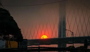 Catastrophe Prints: Rising Sun fire ball over San Francisco Bay bridge from wildfires 2020