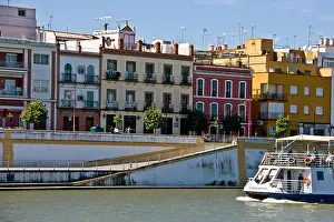 Seville Prints: River Guadalquivir with tourist boat Barrio of Triana Seville Andalusia Andalucia Spain Europe