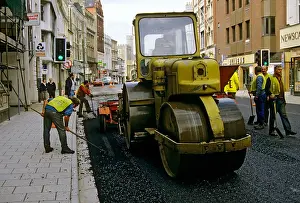 Roller Prints: Road roller used to lay tarmac in city centre Cardiff Wales UK