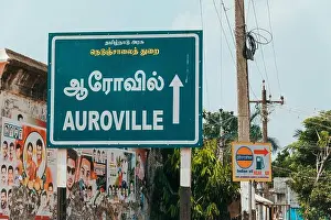 Hindi Prints: A road sign denotes the direction to Auroville