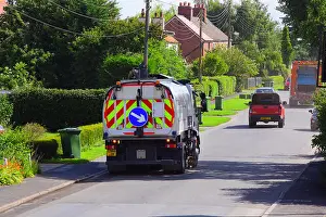 Precise Prints: road sweeping lorry cleaning roadside gutters in street ellerton yorkshire united kingdom