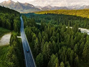 Tatra Prints: Road Trip Car Drive Trough Forest into Mountains Drone View
