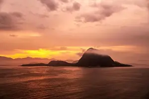 Rock Mountain Prints: Rock Hessa nearby Alesund/Norway in the ocean with clouds in sunrise