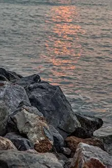 Rocks and sea : View of sea waves hitting rocks on the Calm beach in the morning. No focus, specifically