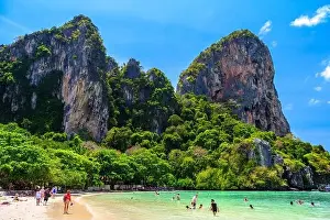 Railay Prints: Rocks, water, tropical white sand beach and people swimming in emerald azure water of bay