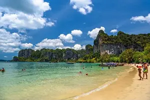 Cliff Mountain Prints: Rocks, water, tropical white sand beach and people swimming in emerald azure water of bay