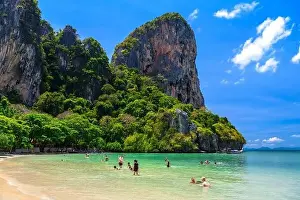 Railay Prints: Rocks, water, tropical white sand beach and people swimming in emerald azure water of bay