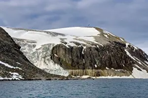Uria Lomvi Prints: rocks waterfall small iceberg and glacier at the Alkefjellet between Spitsbergen and Nordaustlandet on Svalbard