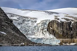 Uria Lomvi Prints: rocks waterfall small iceberg and glacier at the Alkefjellet between Spitsbergen and Nordaustlandet on Svalbard