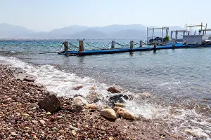 Red Sea Prints: Rocky beach with a floating pier in the Gulf of Eilat Red Sea. Israel