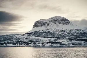 Rocky snowy mountain peak at sunset in the Lyngen Alps in northern arctic Norway