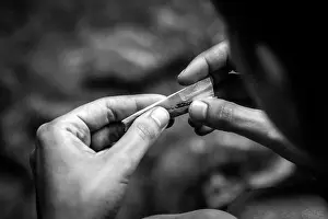 Cigar Prints: Rolling a cigarette by hand, concept of smoking
