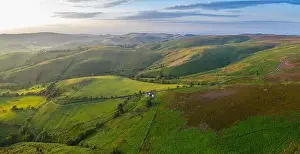 Rolling farming fields in warm sunset light. Panormic aerial view over Shropshire in United Kingdom