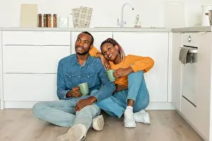 Dreaming Prints: Romantic black couple drinking coffee and looking away