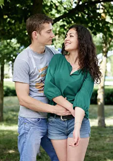Sweetheart Prints: Romantic couple posing in city park, summer season, lovers boy and girl