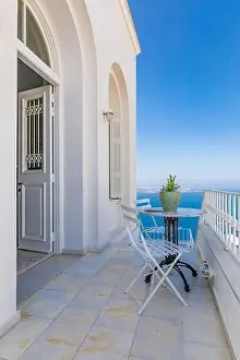 Romantic view, chairs and table with sea view over caldera from resort hotel terrace. Amazing summer travel landscape, luxury vacation