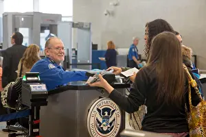 Screening Prints: Romulus, Michigan - A Transportation Security Administration officer checks the identity of passengers at Detroit Metro