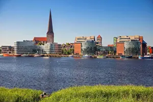 Rostock, Germany. Cityscape image of Rostock riverside with St. Peter's Church during sunny summer day