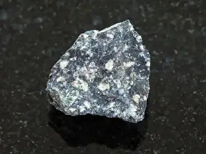 Admission Prints: rough Andesite stone on dark background