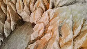 Uneven Prints: From above rough unusual fairy chimney volcanic rock formations against cloudy blue sky on sunny day in Cappadocia