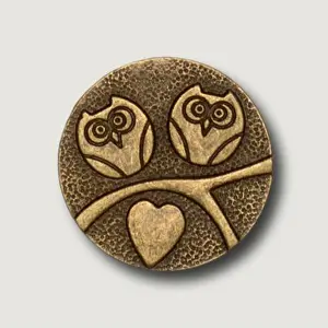 Attach Prints: A round bronze token featuring two owls and a heart, symbolizing love and wisdom
