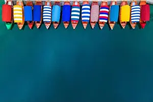 Row of Colorful Boats on Blue Lake. Top Down Drone View. Travel Background