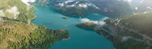 Rugged, forest-covered landscape surrounds Diablo Lake in North Cascades National Park. This mountainous region in Washington is absolutely beautiful