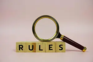 Rules with wooden blocks alphabet letters and Magnifying glass on pink background