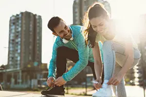 Pause Prints: Runners tying running shoes and getting ready to run