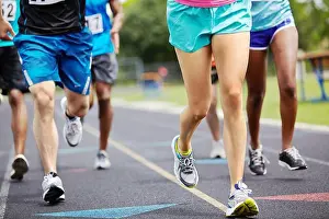 Young Person Prints: Running for the winning title. Cropped close up shot of athletes legs during a race