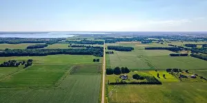 Diminishing Perspective Prints: A rural scene of wisconsin farms during summer with lake winneconnie in the background