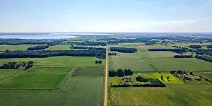 Diminishing Perspective Prints: A rural scene of wisconsin farms during summer with lake winneconnie in the background