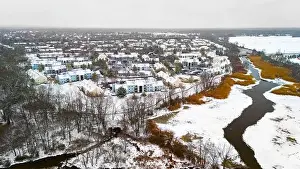 Rural winter aerial view of countryside village at the river covered with snow