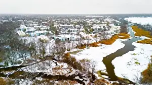 Cinematic Prints: Rural winter aerial view of countryside village at the river covered with snow